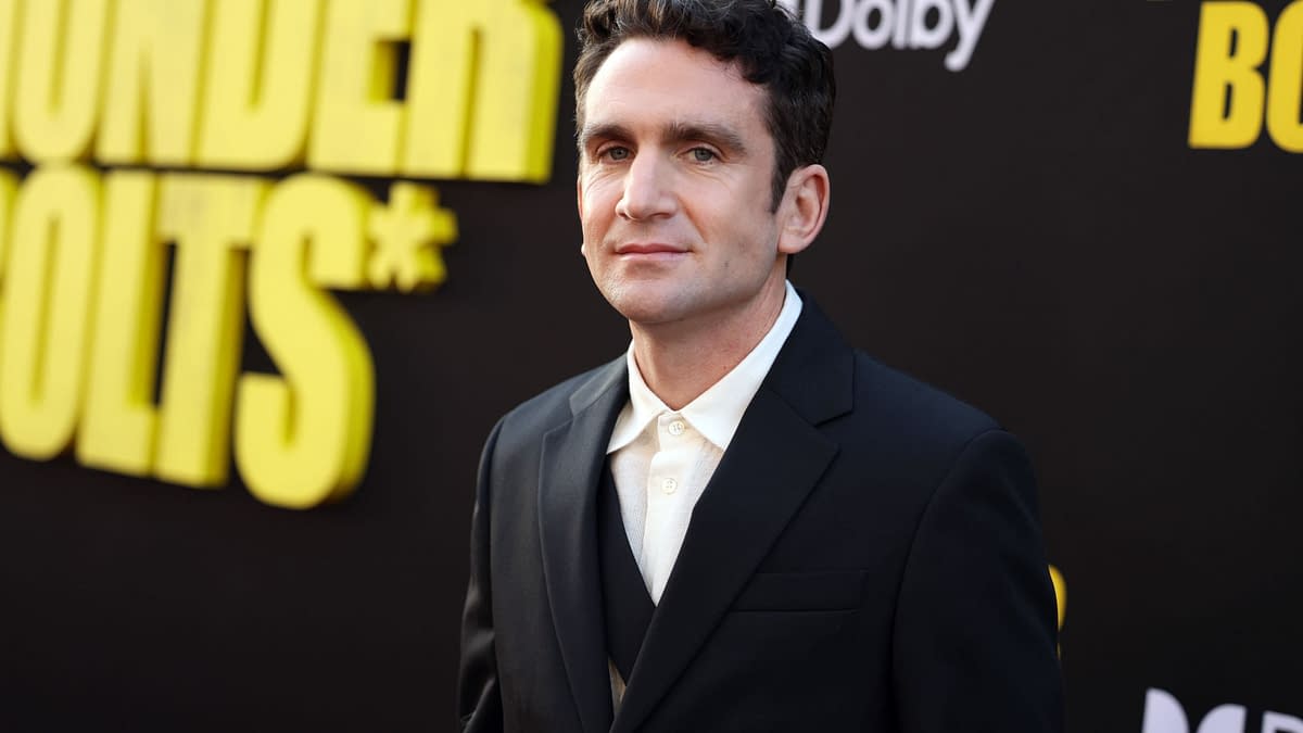 Jake Schreier at the world premiere of Marvel Studios' "Thunderbolts*" in Hollywood, wearing a black suit and white shirt, against a background featuring the event title in bold yellow letters.