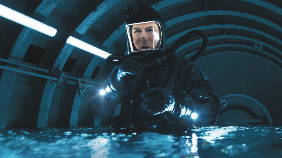 A scene from 'Mission: Impossible - The Final Reckoning' featuring a character in a dark, futuristic environment, wearing a diving suit and helmet with lights, conveying a sense of urgency and action.