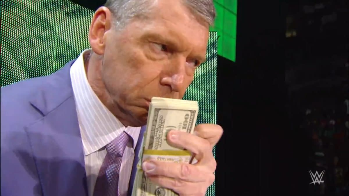Vince McMahon, dressed in a suit, holds a stack of bills close to his face while expressing enjoyment on WWE Raw in 2008. The background features bright green lighting.