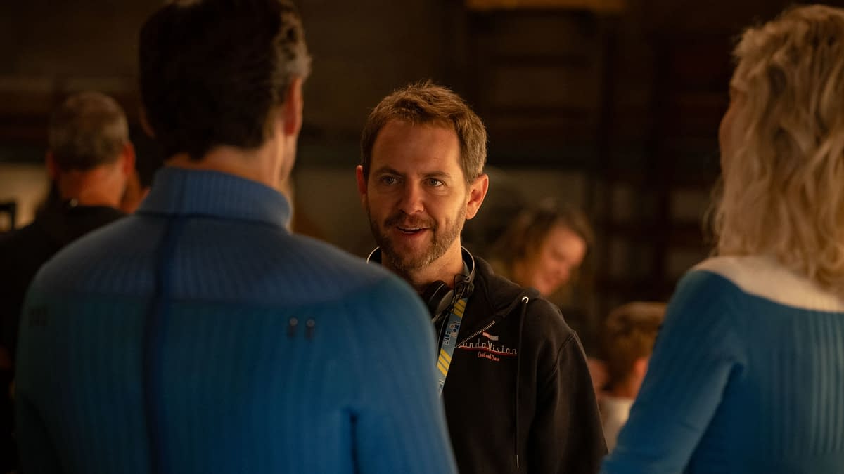 Director Matt Shakman talks with actors on the set of 'The Fantastic Four: First Steps,' set in a studio environment, featuring crew members in the background.