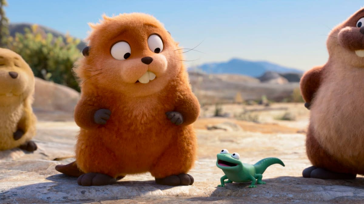 A colorful animated scene from Disney and Pixar's "Hoppers," featuring a cheerful orange beaver character named Loaf, alongside Mabel Beaver and Tom Lizard, who is a small green lizard with large eyes, set in a bright outdoor landscape.