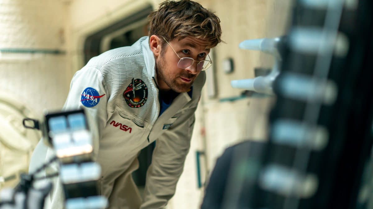 Ryan Gosling portrays Ryland Grace in a scene from the film 'Project Hail Mary', set on a spacecraft interior, wearing a NASA suit with glasses and an intent expression.