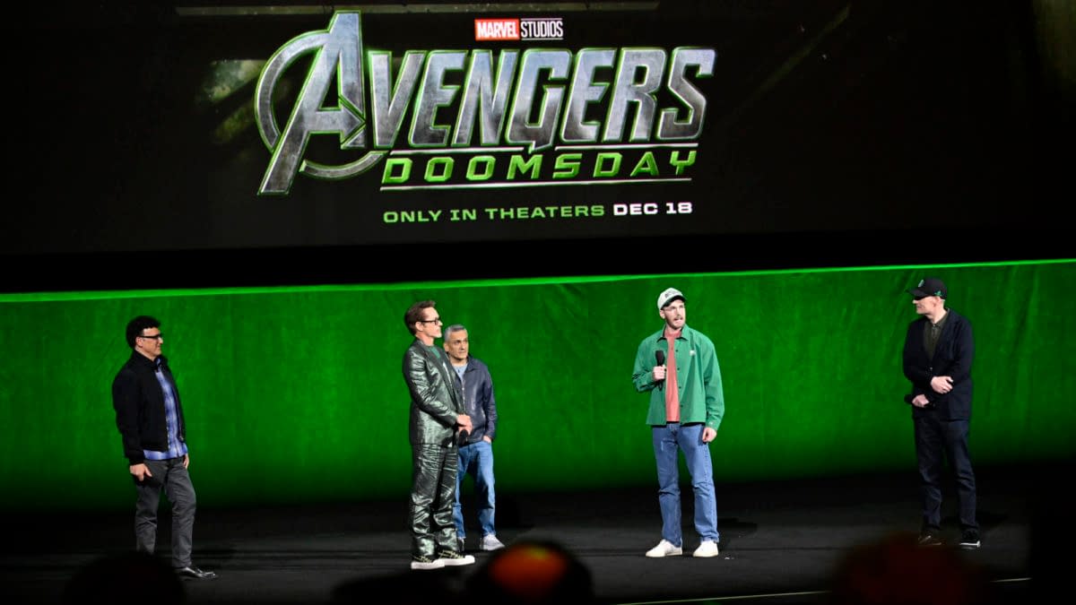 Kevin Feige, Anthony Russo, Joe Russo, Robert Downey Jr., and Chris Evans stand onstage at CinemaCon in front of a large Avengers: Doomsday Marvel Studios title screen.
