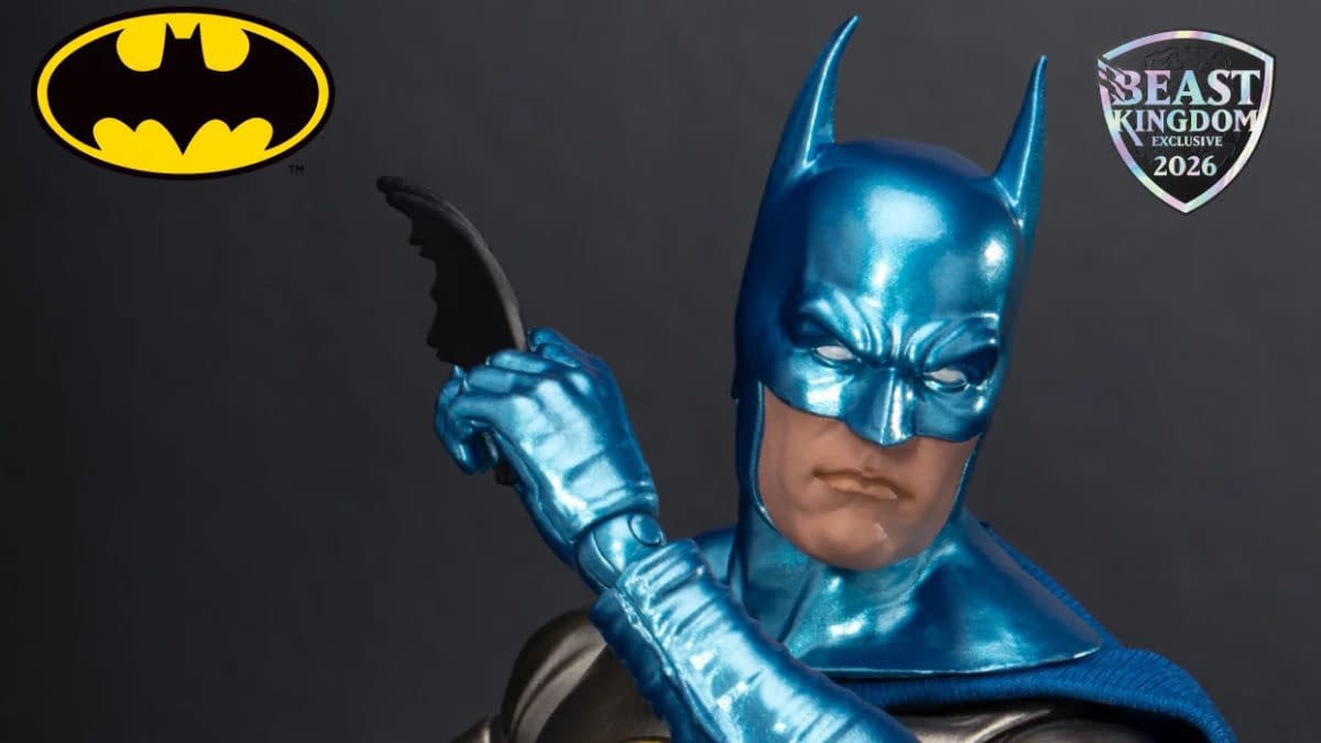 Batman action figure in a metallic blue suit and cowl, posed with a batarang against a dark background. A Beast Kingdom Exclusive 2026 badge and Batman logo appear in the corners.