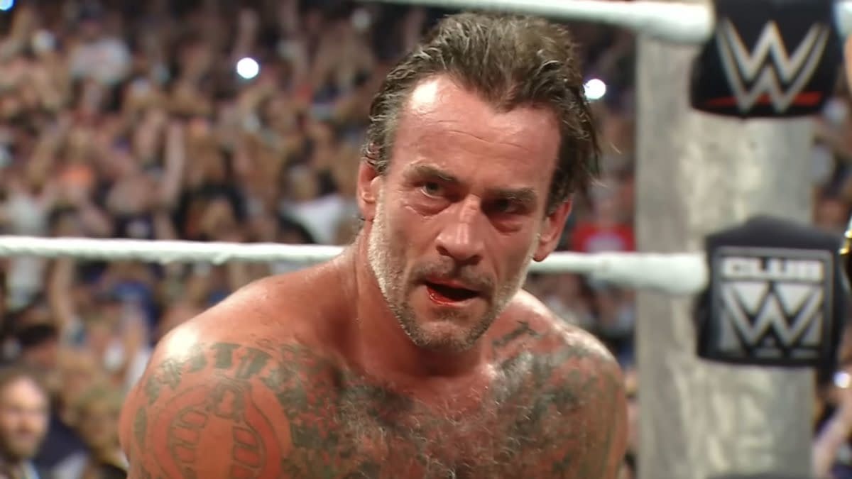 CM Punk, sweaty and intense in the WWE ring, reacts after a hard-fought WWE Championship victory on Raw.