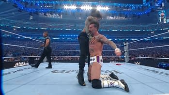 A wrestling match scene features two athletes in a ring, with one executing a dramatic maneuver while the other appears to be in a vulnerable position. The crowd in the background is engaged and excited.