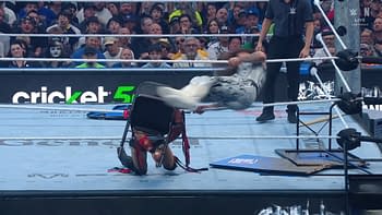 A wrestling ring is in action, featuring a dynamic move where a wrestler is leaping off a chair towards another, while the audience watches with excitement. The scene captures the intensity of a live wrestling event.