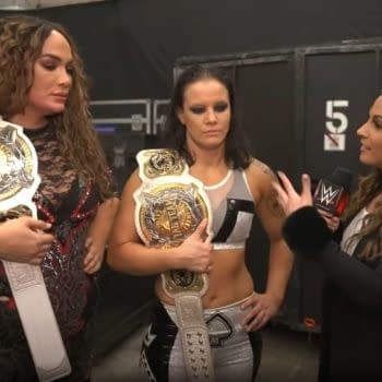 Nia Jax and Shayna Baszler celebrate after retaining the WWE Women's Championships against Sasha Banks and Bianca Belair at WrestleMania.