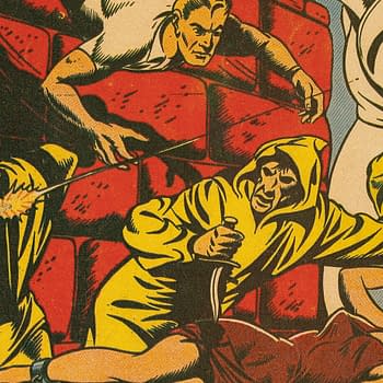 A vintage comic cover features a scene of suspense, showing characters in yellow hooded robes, one aiming a gun, while others appear startled or in distress. The dramatic backdrop includes stone walls, emphasizing the tension in the scene.
