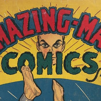 A vintage comic book cover featuring the title 'AMAZING-MAN COMICS' in bold red lettering against a yellow background. The cover shows a character's face with intense eyes, alongside the text for the price and month of publication.