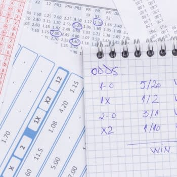 Notebooks and reciepts with betting odds, image by ggserban/Shutterstock.com.