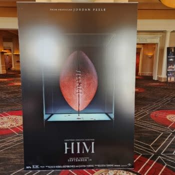 A promotional poster for a film titled 'HIM', featuring a football displayed in a glass case. The poster includes credits to producer Jordan Peele and release information.