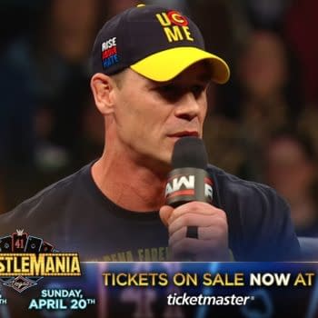 John Cena performing a promo during WWE Raw in Scotland, wearing a cap with the slogan 'U Can't See Me' and holding a microphone, while fans can be seen in the background.