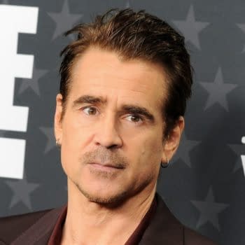Colin Farrell at the 30th Annual Critics' Choice Awards, wearing a stylish dark suit, with a serious expression in front of a star-patterned backdrop.