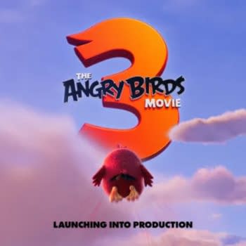 A promotional poster for 'The Angry Birds Movie 3,' featuring the large number 3 in orange against a blue sky with clouds, as a red bird takes flight below. The text 'LAUNCHING INTO PRODUCTION' is displayed at the bottom.