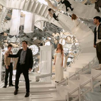 Scene from the film 'Now You See Me: Now You Don’t' featuring characters Bosco, Daniel Atlas, Henley Reeves, and Charlie in a surreal, mirror-filled environment with twisting white staircases and bright light fixtures.