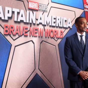 Anthony Mackie attends the premiere of 'Captain America: Brave New World' at TCL Chinese Theater in Hollywood, wearing a dark suit and standing in front of a backdrop featuring the movie's logo.