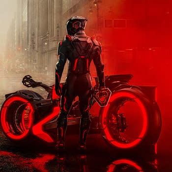 A dramatic illustration from 'TRON: Ares' featuring a futuristic figure in a sleek, black outfit, standing beside a high-tech motorcycle with glowing red accents, set against a foggy urban backdrop.