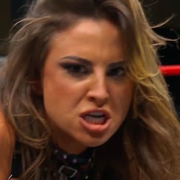 Harley Cameron, a wrestler, shows an intense expression during a match on AEW Collision, with wrestling ropes visible in the background.