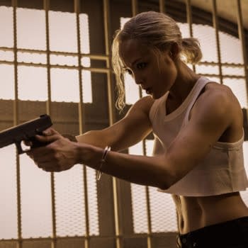 Pom Klementieff as Paris in a tense action scene from 'Mission: Impossible - The Final Reckoning,' aiming a handgun while dressed in a white crop top.
