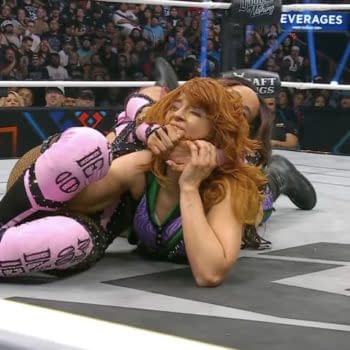 Mercedes Moné applies a submission hold to Jamie Hayter, who is struggling against the move in a wrestling ring during the finals of the Owen Hart Tournament at AEW Double or Nothing. The audience watches in anticipation.