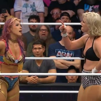 Mina Shirakawa and Toni Storm face off in a wrestling ring, engaged in a heated exchange after their match at AEW Dynamite. The crowd is visible in the background, highlighting the tension of the moment.