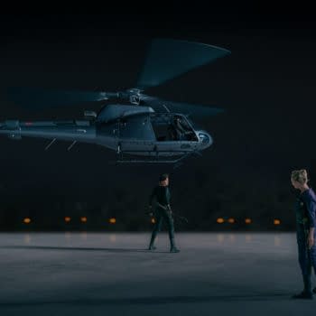 A dramatic scene from 'The Old Guard 2' featuring a helicopter hovering above two characters, one standing with a weapon, and the other looking down. The atmosphere is tense and dark, highlighting the intense action of the film.