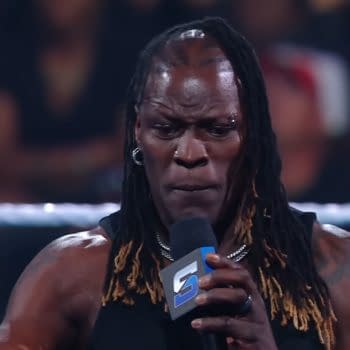 R-Truth delivers an emotional promo on WWE SmackDown, expressing deep feelings to the audience while holding a microphone and showing intense expression.