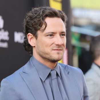 Lewis Pullman is seen attending the World Premiere of Marvel Studios' "Thunderbolts," wearing a light blue suit and gray tie, against a black backdrop. The event took place at the Dolby Theatre in Hollywood.