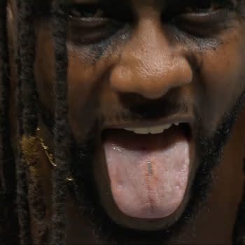 A close-up of wrestler Swerve Strickland at AEW Double or Nothing, displaying a tongue with a staple embedded in it, showcasing the aftermath of Anarchy in the Arena, a hardcorea wrestling match.