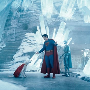 Superman stands in an icy, crystalline environment, interacting with a dog wearing a cape, while a humanoid robot observes nearby. The scene conveys a whimsical mix of superhero and science fiction elements.