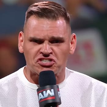 Gunther passionately delivers a promo on WWE Raw, holding a microphone and showcasing an intense expression. The audience is visible in the blurred background, creating a lively atmosphere.