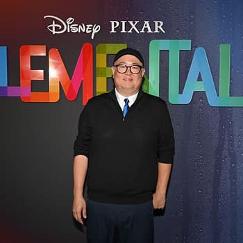 Director Peter Sohn stands in front of a colorful backdrop featuring the title "Elemental" at the UK Gala Screening in London, promoting Disney and Pixar's film.
