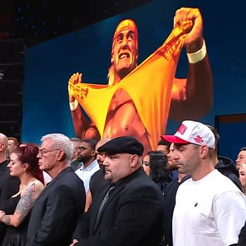 A group of WWE Superstars and Legends, including CM Punk, stands in tribute during a solemn moment on WWE Raw, with an iconic image of Hulk Hogan displayed behind them.