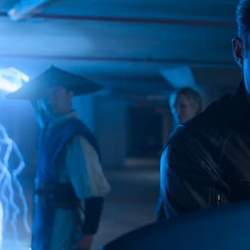 A dramatic scene from Mortal Kombat II, featuring a character in a leather jacket looking intently at a glowing blue lightning effect, while another character in a traditional outfit and hat stands behind him.