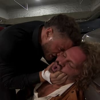 In a dimly lit parking garage, MJF aggressively assaults Hangman Adam Page, pinning him against a car. Page appears vulnerable as MJF grips his face forcefully in this segment that aired on AEW Dynamite.