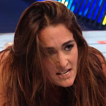 Nikki Bella shows frustration during her wrestling match against Becky Lynch at WWE Clash in Paris, with her intense expression conveying the intensity of the moment.