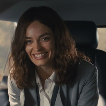 Emma Mackey portrays Ella McCay, smiling in a vehicle. The scene captures a warm moment from 20th Century Studios' film 'ELLA MCCAY'.
