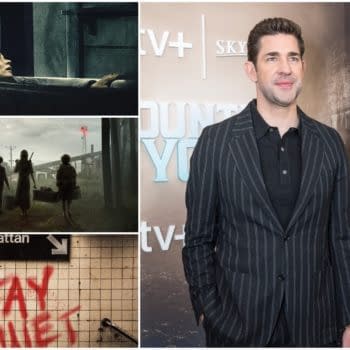John Krasinski stands in a well-dressed, striped suit at a promotional event, with a backdrop related to a Quiet Place film. The image references the suspenseful themes of the A Quiet Place series.