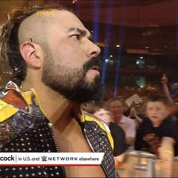 A wrestler with a distinctive mohawk hairstyle and a colorful jacket enters the Royal Rumble arena, where fans are cheering and reaching out to him. The energy of the crowd is palpable, with bright lights illuminating the scene.