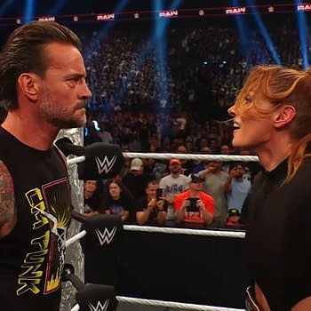 Becky Lynch confronts CM Punk at WWE Raw, both showcasing intense expressions in the ring. The audience is engaged and visible in the background.