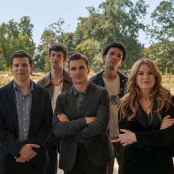 A promotional image featuring the cast of 'Now You See Me, Now You Don't', including Woody Harrelson, Jesse Eisenberg, Isla Fisher, and others, posing together outdoors in a natural setting.