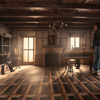 A scene from 'Now You See Me: Now You Don’t' featuring Dave Franco as Jack Wilder sitting on a shelf and Ariana Greenblatt as June standing on the floor in a stylishly furnished room. The room is illuminated by natural light and includes a grand piano, a harp, and vintage decor.