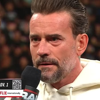 A wrestler, CM Punk, intensely recites a scripted promo on WWE Raw, with an emphasis on a controlled environment that mitigates potential confrontations. The setting is charged as he delivers his lines to another wrestler, shown partially from the side.