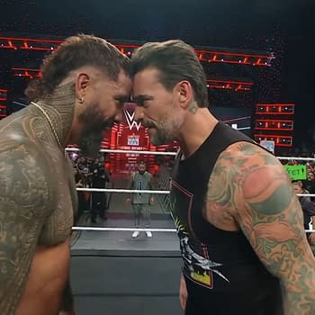 CM Punk and Jey Uso are playfully pressing their foreheads together in a humorous moment on WWE Raw, with a wrestling ring and an enthusiastic crowd in the background.