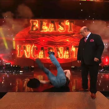 Brock Lesnar is seen slipping and falling on stage during his entrance on WWE Raw, while Paul Heyman looks on with concern amid flashing lights and smoke.