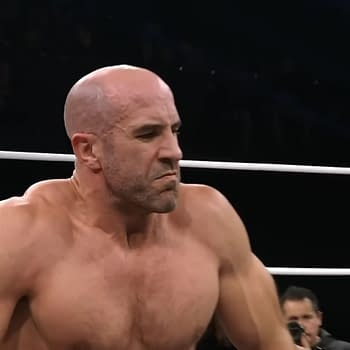 Claudio Castagnoli, a bald wrestler with a muscular build, is actively competing in the Continental Classic on AEW Dynamite. He appears focused and determined in the ring, with the audience visible in the background.