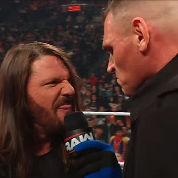 AJ Styles passionately confronts Gunther during a promo on WWE Raw, with an intense crowd visible in the background.
