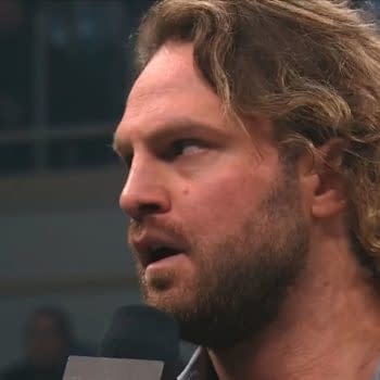 Hangman Adam Page stands in the ring during AEW Dynamite, addressing the audience with a serious expression as he makes a startling promise.