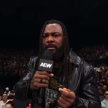 Swerve Strickland speaks to the crowd on AEW Dynamite, holding a microphone and wearing a leather jacket. Fans are visible in the background, showing enthusiasm for the event.